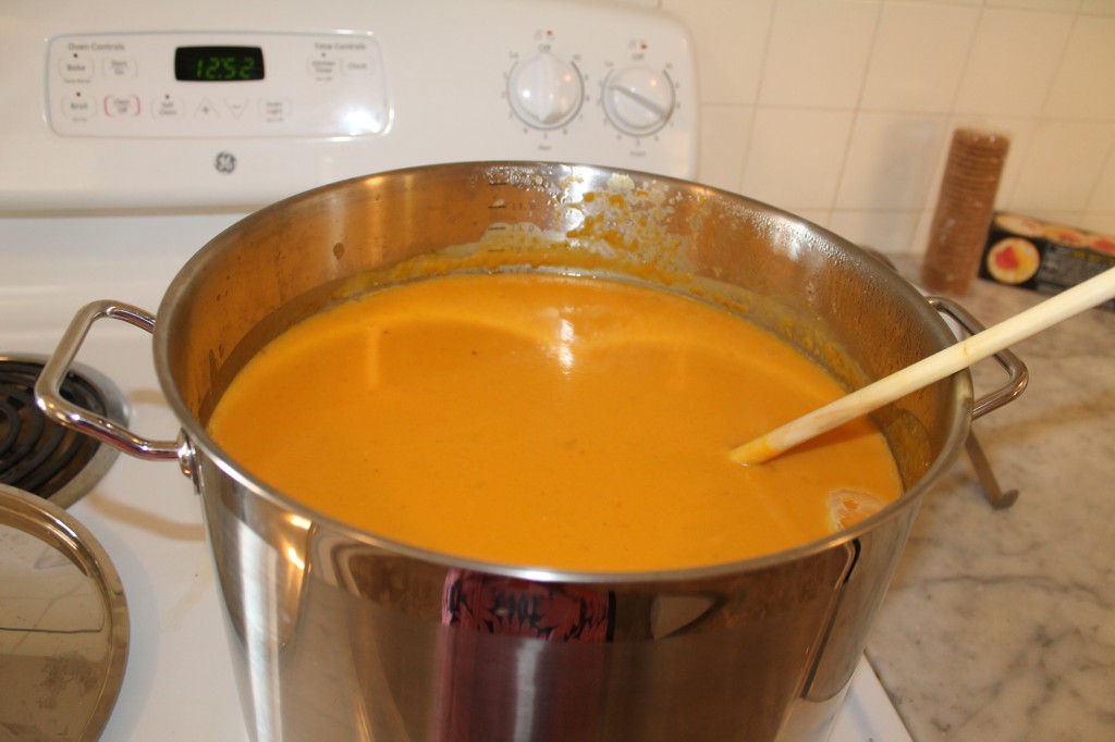 a giant, 15 quart vat of butternut squash soup. I HATE working with butternut squash (not quite as much as I hate working with eggplant, but it's up there). I had to peel, HACK, cube, and dump four big squashes into this thing. I thought my hands would never recover.