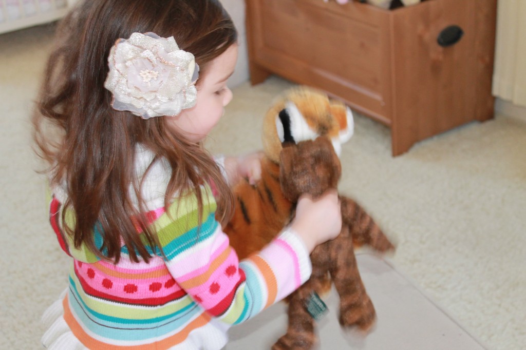 Here she is doing a happy dance with her stuffed animals because cat sent her a postcard.