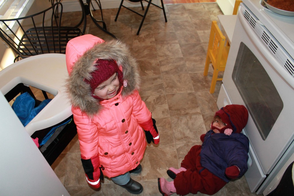 The two girls bundled before their snow fort play session.