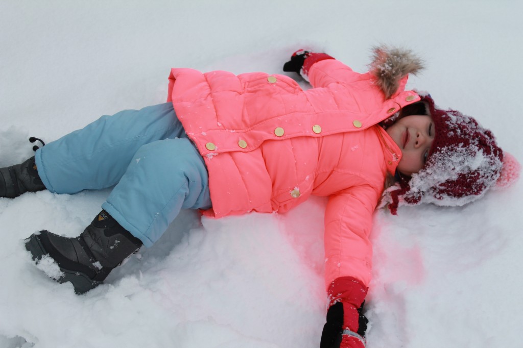 :Lydia busied herself decorating the ground with snow angels.