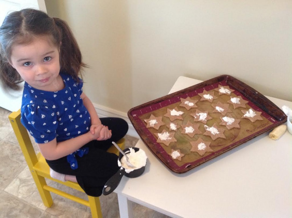 After I took this photo, I taught her how to spread the icing all over the cookie.
