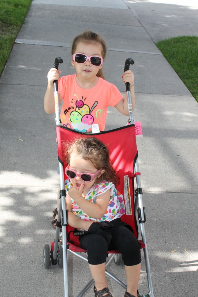 On the way to the library, Lydia loves to push Mary in the stroller.