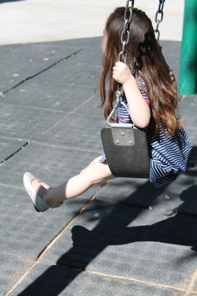 Lydia swinging at the playground. 