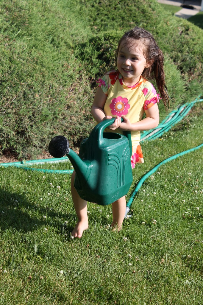 Lydia running to pour the watering can on Abe and Mary.
