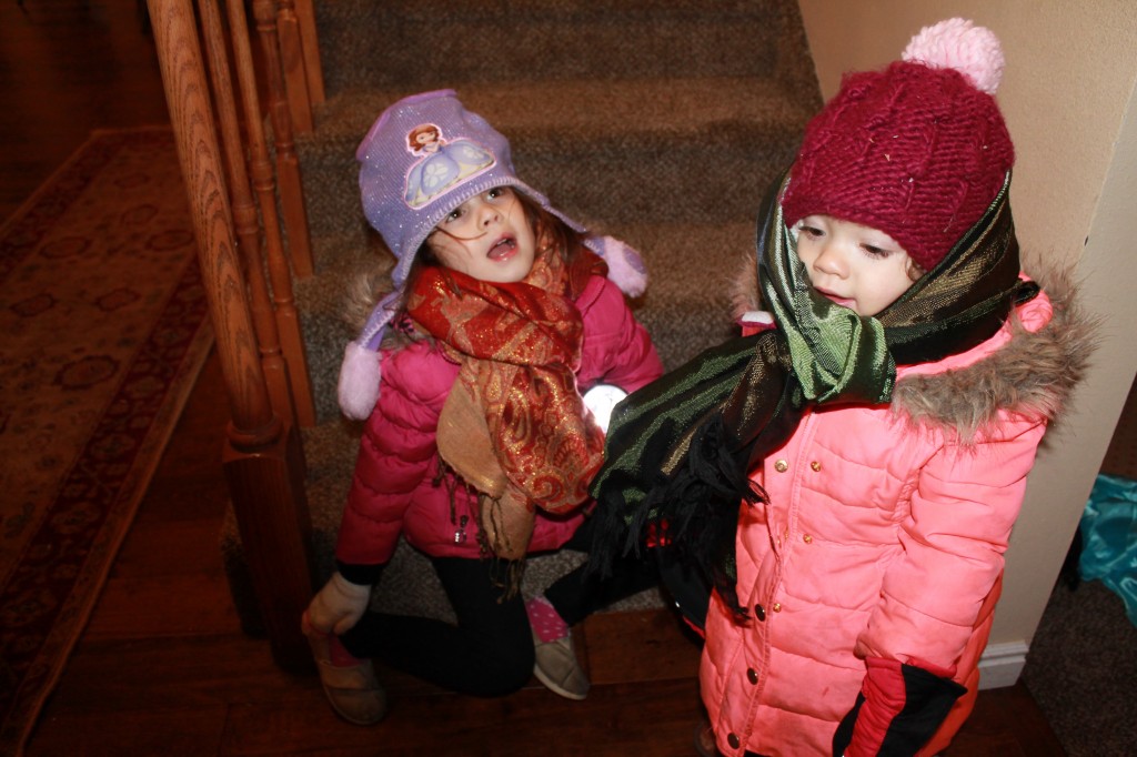Today was an outdoorsy day in general. Abe took the girls outside for an hour after dinner. They love to use their flashlights and "explore" the yard. Abe dressed them up in my old scarves. They were prepared for a far different climate than the one that we experienced today.