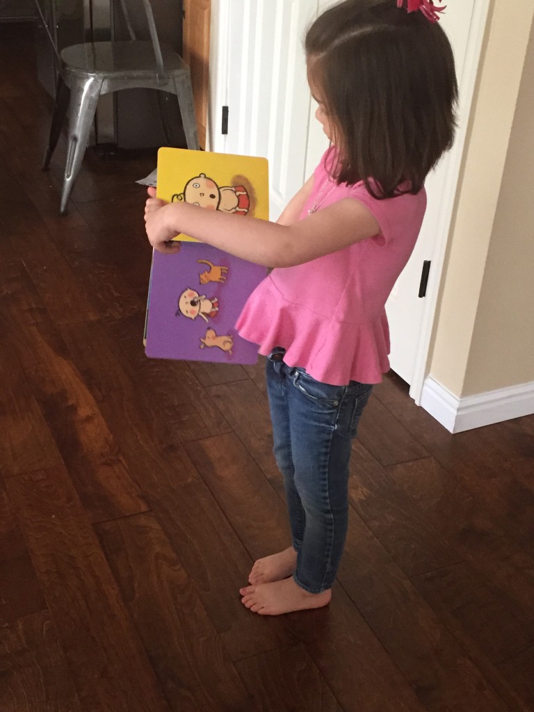 After cuddling, we went on a search through the whole house for a great horned owl. Lydia is consulting her "instructions book" (actually a potty book) on where to find the owl.