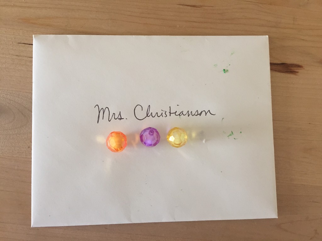 Lydia wrote a thank-you note to her teacher and insisted on glueing the beads from her broken bracelet to it for decoration. I thought it looked really pretty.