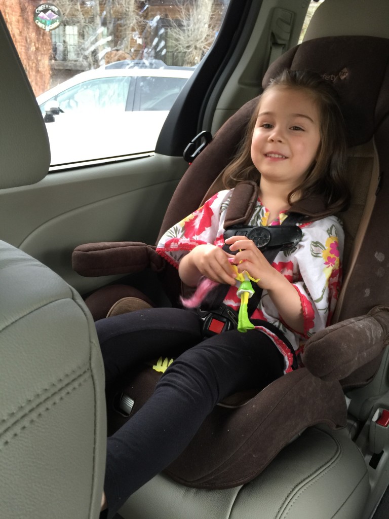Riding in the car with her McDonald's toy.