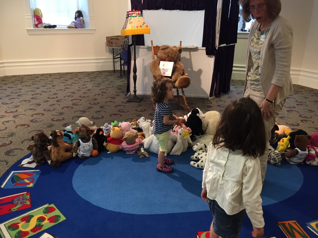 The animals got dropped off at stuffed animal story time. A big stuffed bear was reading books to all of the animals.