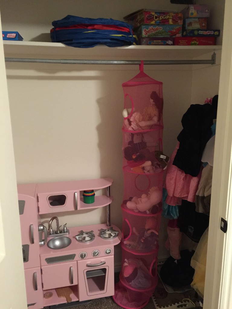 I tried to maximize the use of this closet. It worked! The girls had stopped playing dress up because their overflowing, stuffed trunk was a deterrent; now they can see their clothes and they play with them. They also play with those soft dolls stacked in the organizer. They never got played with before. And, although they never quite stopped playing with their kitchen, they play with it a whole lot more now that it isn't crammed in the craft room.