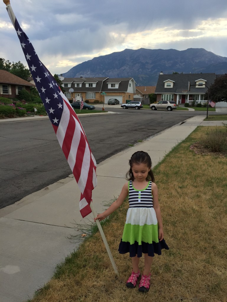 On our way out the door to the parade, Lydia ran to the flag and said, "Mommy, take a picture of me with the flag!" Happy to do so. On all the patriotic holidays (Memorial Day, Veteran's Day, the 4th of July, and Pioneer Day), the young men in our ward go out in the wee hours of the morning and plant a flag in the yard of each member's house. They remove it the next morning.