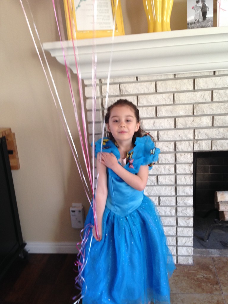 Enjoying her balloons and Cinderella dress.
