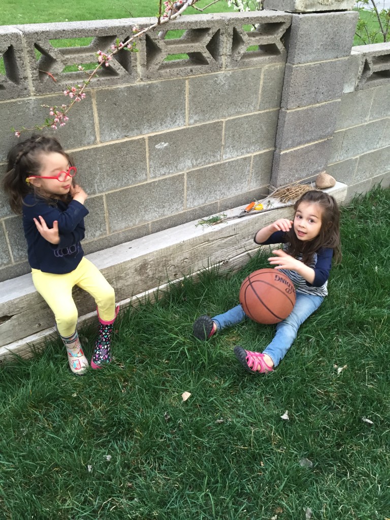 To my untrained eye, it appeared that Lydia and Mary were putting grass, garden tools and rocks on a wood beam outside. But Mary and Lydia informed me that they were making a doll. They enthusiastically built this doll for a solid half-hour today.