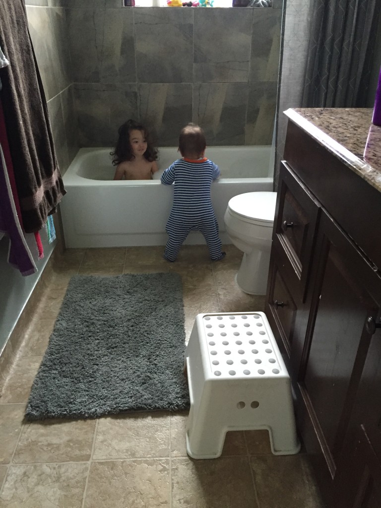Ammon crawled to the bathtub and pulled himself up to peek in at Mary's fun bath. This was the first time I had ever seen him do that. 