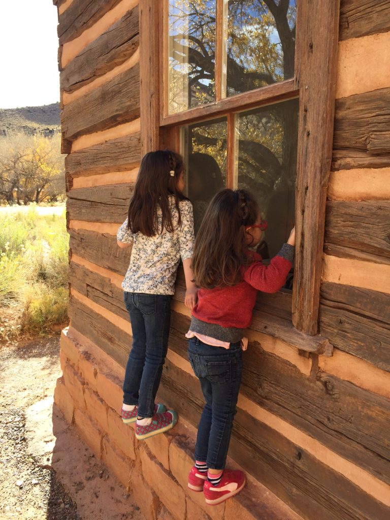 My favorite stop was the Fruita school house. This was where the Mormon pioneer children attended school. We should have taken a picture of the whole building. It was so quaint! And the setting was spectacular. But we did get some pictures of the girls peeking into the school house (it was locked).