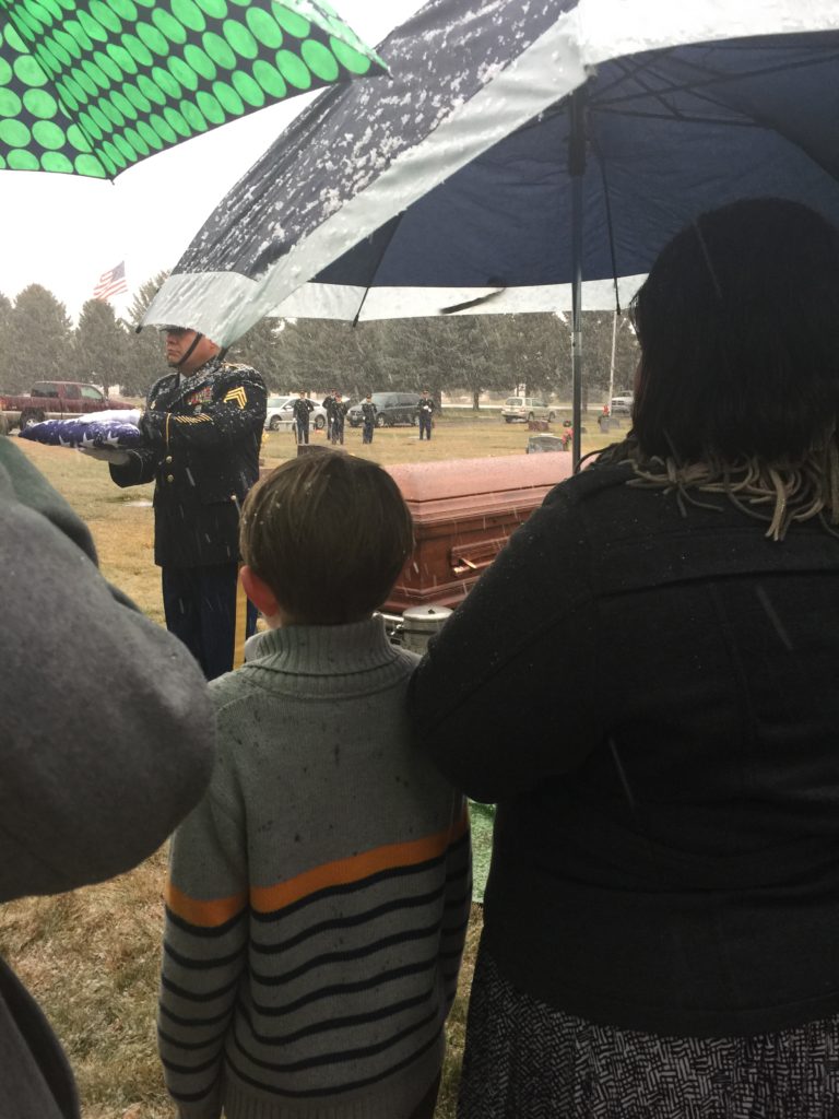You can see the honor guard folding the flag in the snow. 