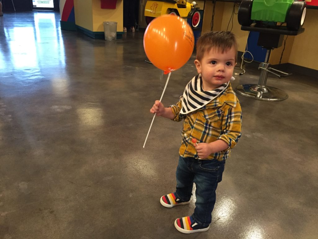 Ammon was a whole lot happier since he didn't have to have his hair cut. He had a balloon in one hand, a lollipop in the other, and he was happy as a clam.