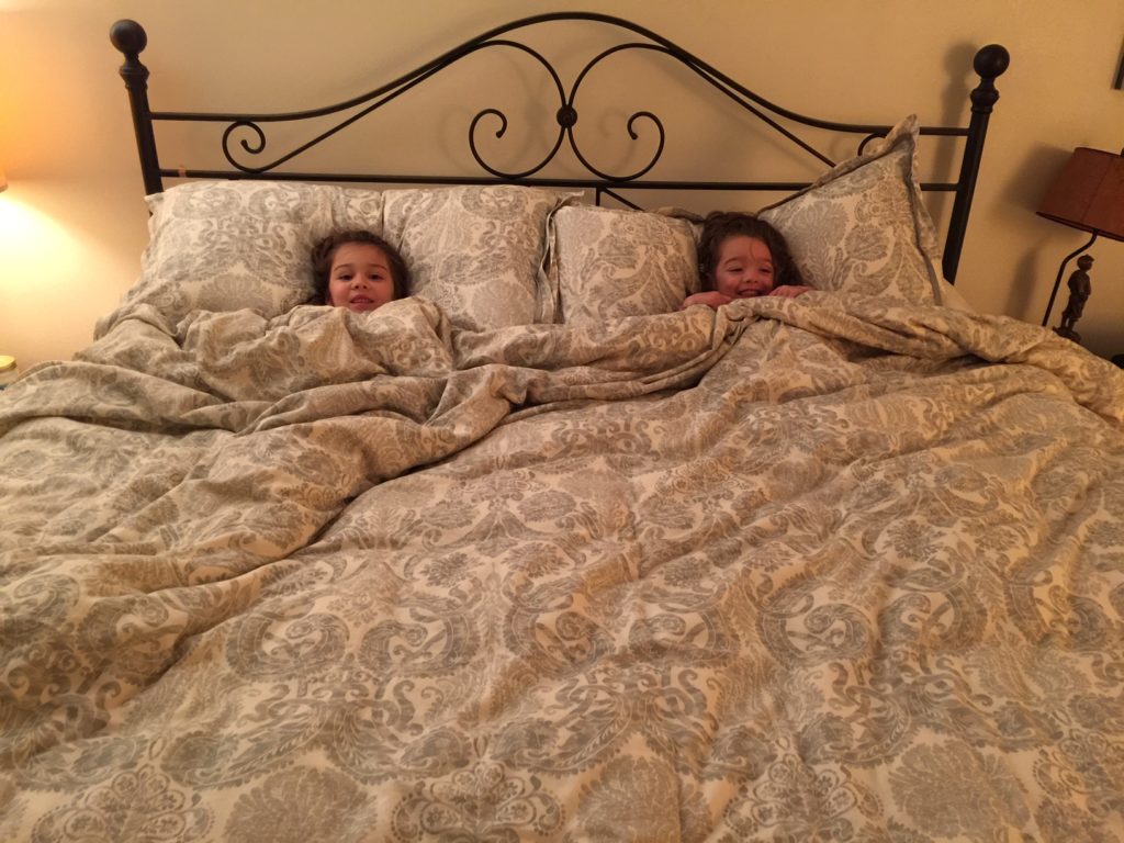 This is the girls at home, snuggling in our bed while I was gone.
